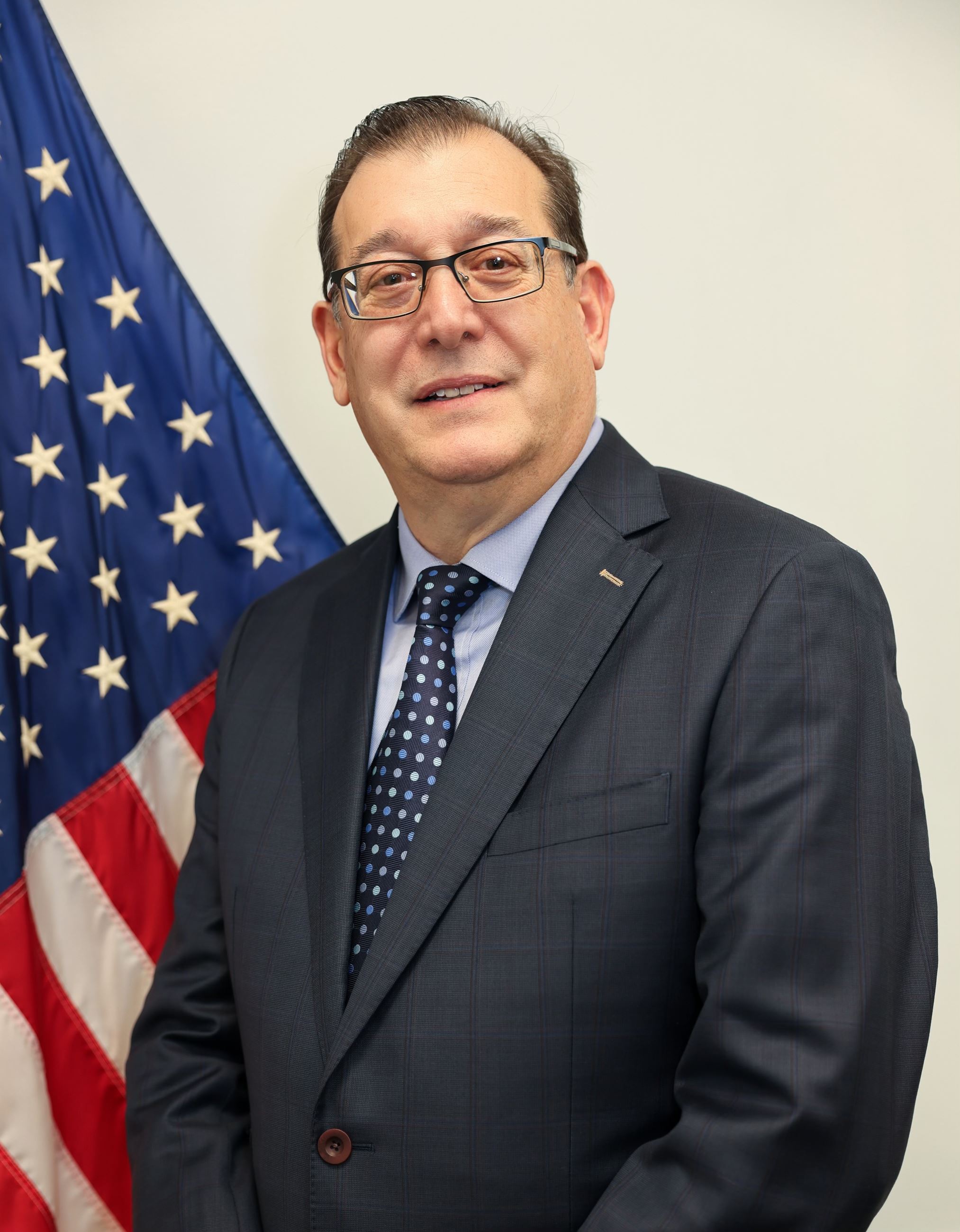picture of William Alexopoulos by an American Flag, Town Council President